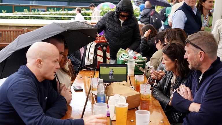 Spectators watch the England v Switzerland UEFA Euro 2024 Quarter Final match on day six of the 2024 Wimbledon Championships at the All England Lawn Tennis and Croquet Club, London. Picture date: Saturday July 6, 2024.