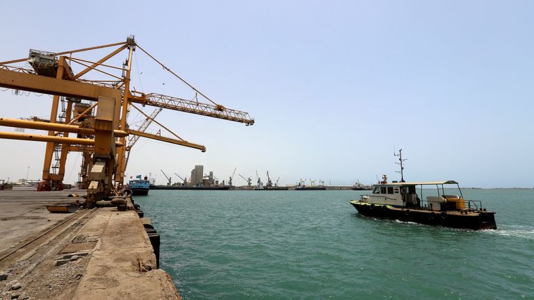 A coastguard boat sails past a commercial container ship docked at the Houthi-held Red Sea port of Hodeidah, as a container ship carrying general commercial goods docked at the port for the first time since at least 2016, in Hodeidah, Yemen February 25, 2023. REUTERS/Khaled Abdullah