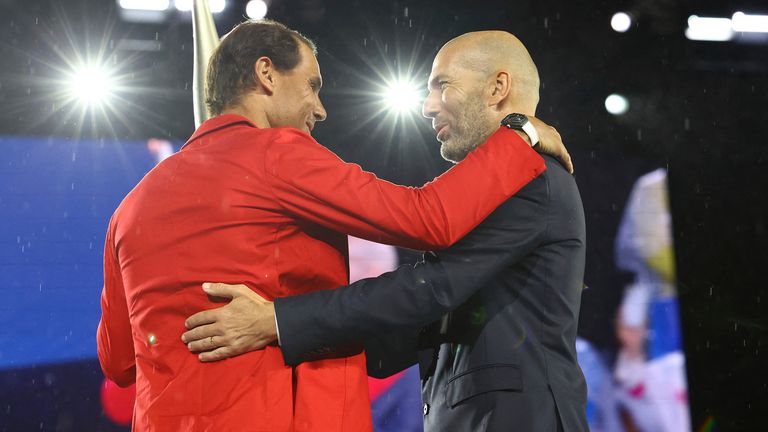 Zinedine Zidane passes the Olympic torch to Rafael Nadal. Pic: AP