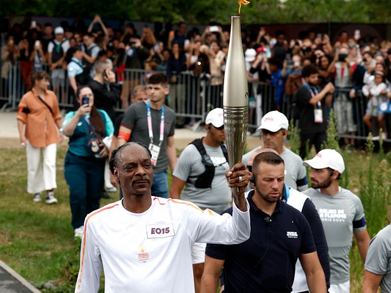 Olympic torchbearer Snoop Dogg during the torch relay.  Photo: Reuters