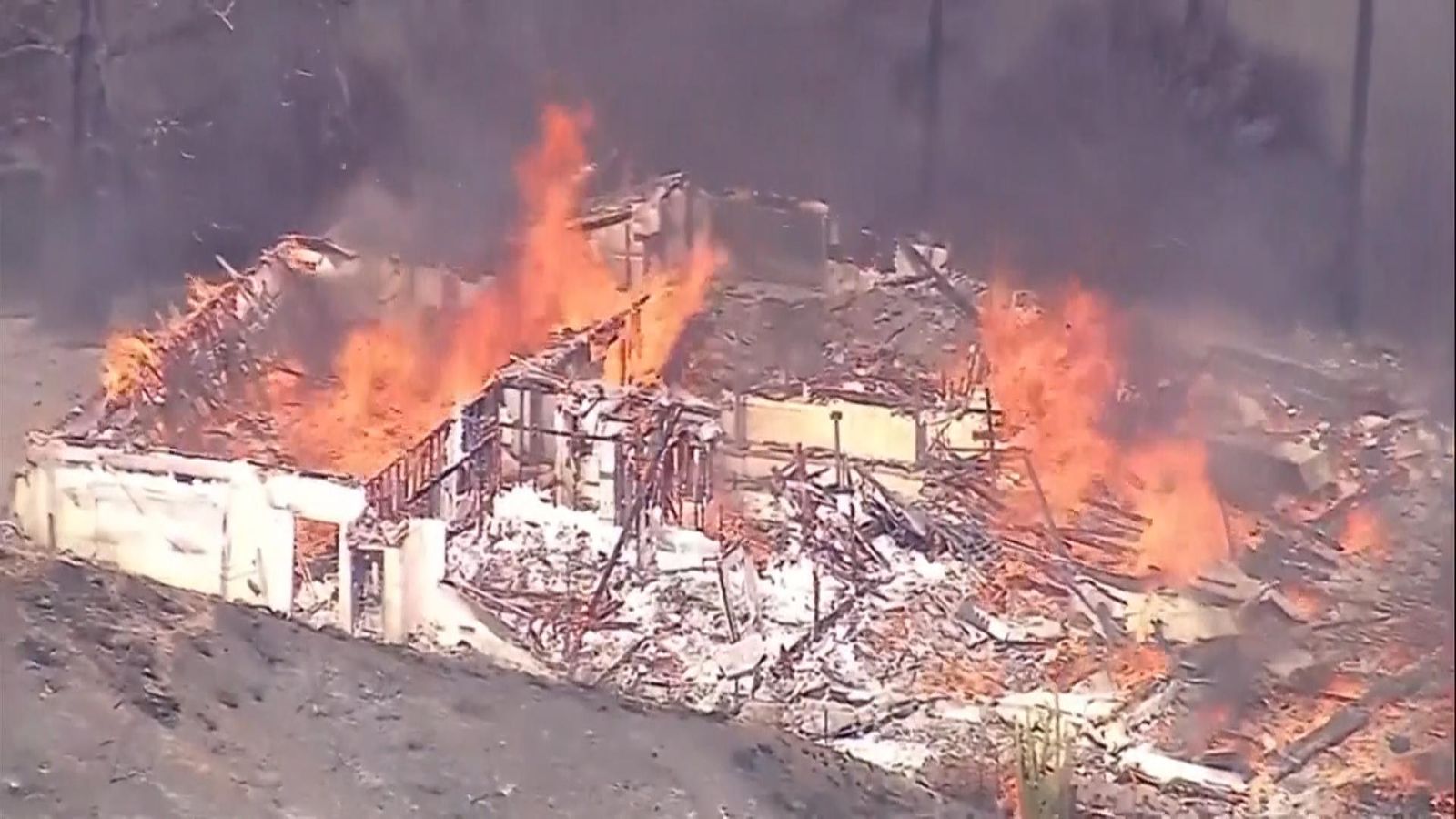 Firefighters battle brush fire as homes burn in California blaze | US ...