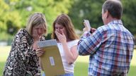 Hannah Greenwood reacts with her parents after receiving good A-level results at Solihull School in the West Midlands. Pic: PA