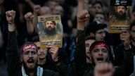 Hezbollah hold up portraits showing commander Fuad Shukr who was killed by an Israeli airstrike. Pic: AP
