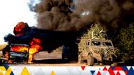 A Ukrainian armoured military vehicle drives past a burned car near the Russian-Ukrainian border, Sumy region, Ukraine, Wednesday, Aug. 14, 2024. (AP Photo/Evgeniy Maloletka)