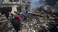 Palestinians search debris after an Israeli strike on a school run by UNRWA, the U.N. agency helping Palestinian refugees, in Nuseirat, Gaza Strip, Tuesday, May 14, 2024. (AP Photo/Abdel Kareem Hana)