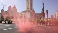Police officers stand guard during a protest against illegal immigration, in Liverpool, Britain, August 3, 2024. REUTERS/Belinda Jiao
