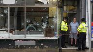 Police officers outside a damaged butchers shop on Murray Street in Hartlepool following a violent protest on Wednesday evening, where demonstrators set fire to a police car and pelted officers with missiles, including glass bottles. Picture date: Thursday August 1, 2024.