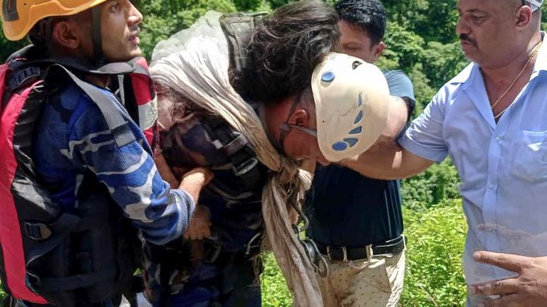 APF personnel help a person after a bus carrying Indian pilgrims fell into a river near Abukhaireni.
Pic: AP