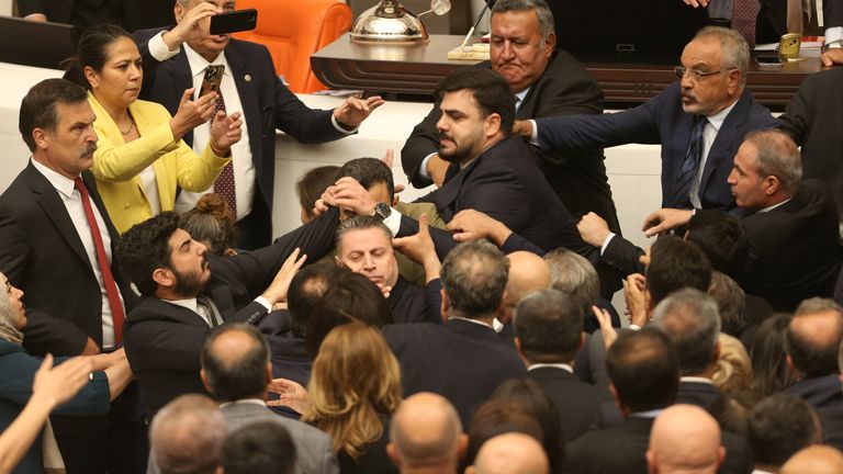 Turkey's ruling AK Party (AKP) lawmakers and opposition lawmakers scuffle during an extraordinary meeting of the Turkish parliament to discuss jailed opposition lawmaker Can Atalay's return to the assembly, in Ankara, Turkey August 16, 2024. REUTERS/Cagla Gurdogan
