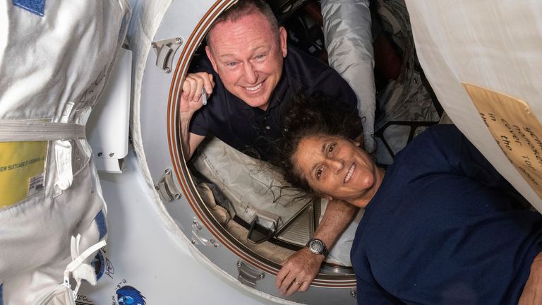 In this photo provided by NASA, Boeing Crew Flight Test astronauts Butch Wilmore, left, and Suni Williams pose for a portrait inside the vestibule between the forward port on the International Space Station's Harmony module and Boeing's Starliner spacecraft on June 13, 2024. (NASA via AP)