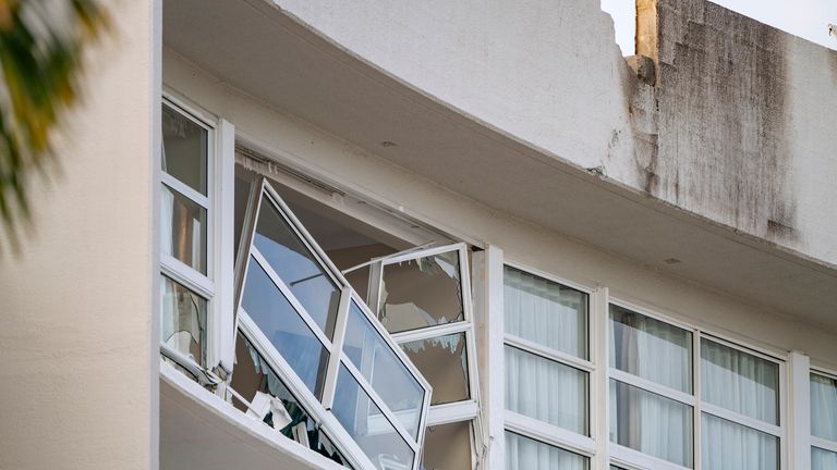 Broken windows hang from the DoubleTree Hotel in Cairns, Australia. Pic: AP