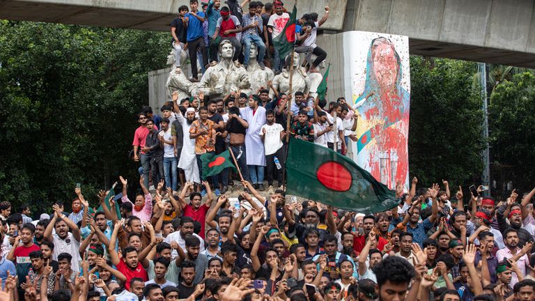 Protesters climb a public monument as they celebrate after getting the news of Prime Minister Sheikh Hasina's resignation, in Dhaka, Bangladesh.
Pic: AP