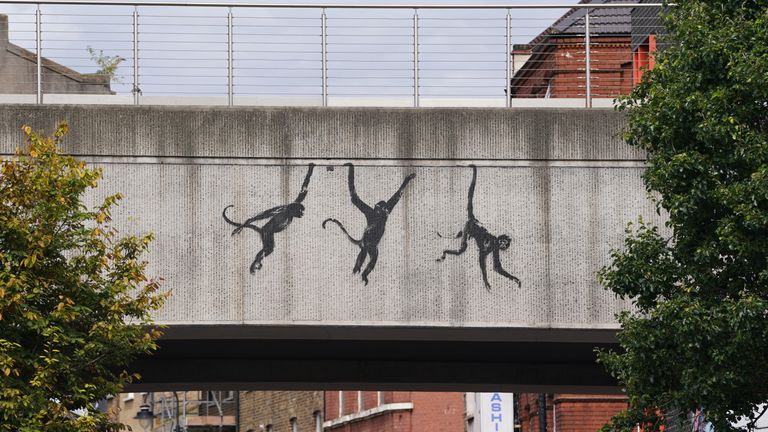 A new artwork depicting three monkeys unveiled by Banksy, painted on a bridge in Brick Lane.
Pic: PA