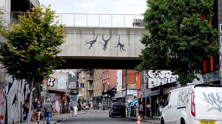 A new artwork depicting three monkeys unveiled by Banksy, painted on a bridge in Brick Lane.
Pic: PA