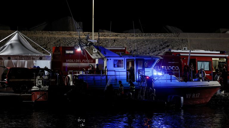 Emergency and rescue service officials work at a port near the site where a luxury yacht sank, in Porticello, near the Sicilian city of Palermo, Italy, August 20, 2024. REUTERS/Louiza Vradi