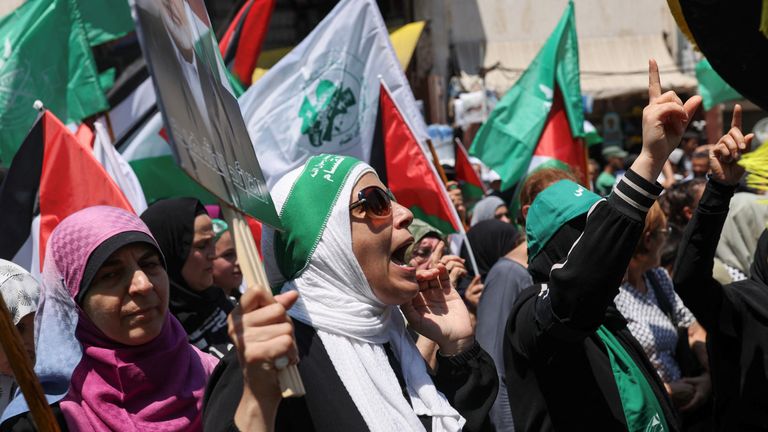 Demonstrators hold flags during a protest against the killing of Hamas chief Ismail Haniyeh in Iran, in Beirut, Lebanon August 2, 2024. REUTERS/Emilie Madi