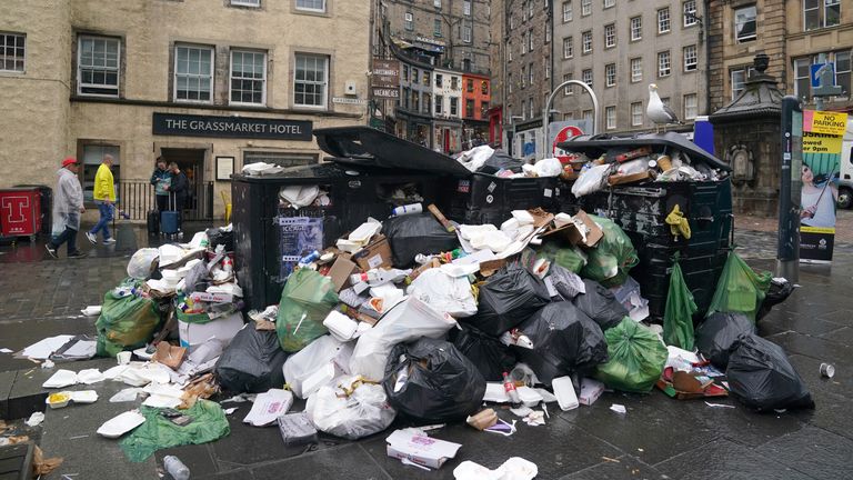 Overflowing bins in the Grassmarket area of Edinburgh where cleansing workers from the City of Edinburgh Council are on the fourth day of eleven days of strike action. Workers at waste and recycling depots across the city have rejected a formal pay offer of 3.5 percent from councils body Cosla. Picture date: Wednesday August 24, 2022.