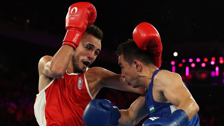 Paris 2024 Olympics - Boxing - Men's 51kg - Final - Roland-Garros Stadium, Paris, France - August 08, 2024. Hasanboy Dusmatov of Uzbekistan in action against Billal Bennama of France. REUTERS/Maye-E Wong