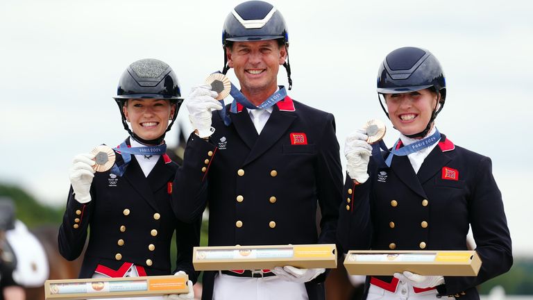 Carl Hester, Charlotte Fry and Becky Moody celebrate getting bronze medals in equestrian (team dressage)