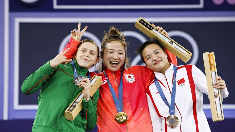 From left: Silver medalist Nicka of Lithuania, gold medallist Ami of Japan and bronze medalist 671 of China. Pic: AP