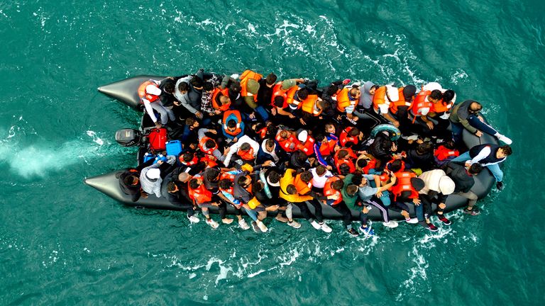 An inflatable dinghy carrying migrants makes its way towards England in the English Channel.
Pic: Reuters