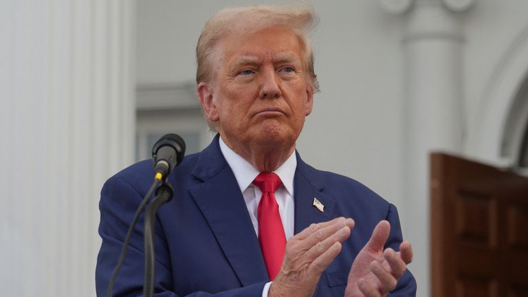 Donald Trump applauds during a press conference at Trump National Golf Club, in Bedminster, New Jersey