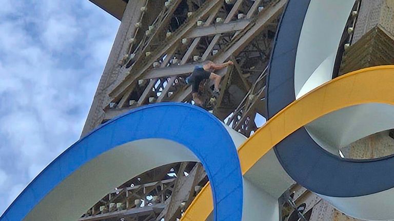 A man climbs the Eiffel Tower during the 2024 Summer Olympics. Pic: AP/Nicky Worlock