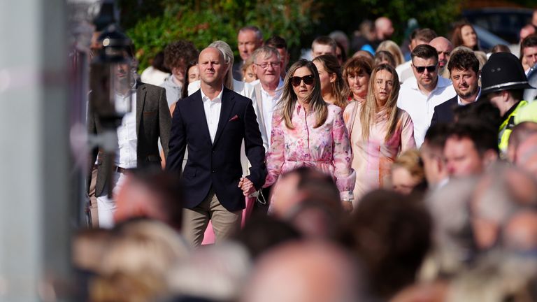 Mourners walk behind the horse-drawn carriage carrying the coffin of  Elsie Dot Stancombe.
Pic: PA