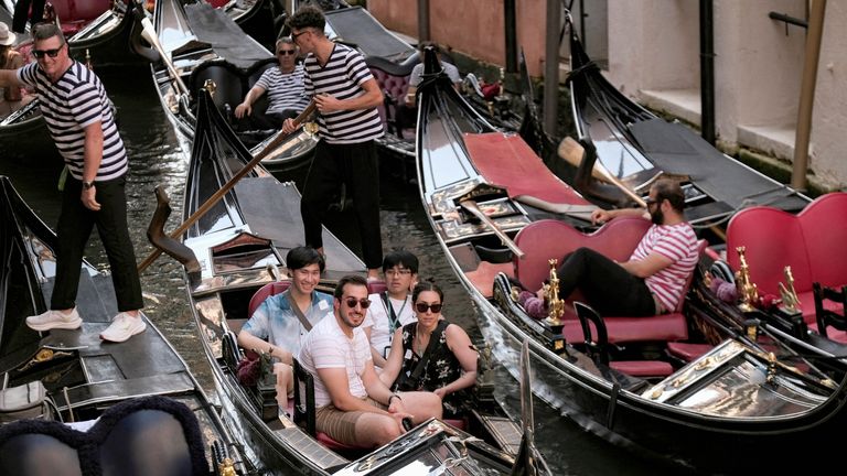 Day-trippers take a gondola tour, on the last day of the experimental 5 euro entry fee to visit Venice, in Venice, Italy, July 14, 2024. REUTERS/Manuel Silvestri