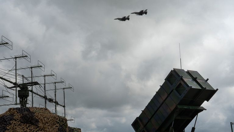 The Ukrainian Air Force's F-16 fighter jets fly over a Patriot Air and Missile Defense System in an undisclosed location in Ukraine, Sunday, Aug. 4, 2024. The F-16 fighter jets that have been delivered to Ukraine by Western countries will be flying sorties in Ukrainian skies and helping the country's current fleet of Soviet-era jets to counter Russia's invasion. (AP Photo/Efrem Lukatsky)