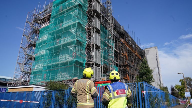 A firefighter and a fire safety officer looking at the scene in Dagenham, London, following a blaze at a block of flats on Freshwater Road. 
Pic PA