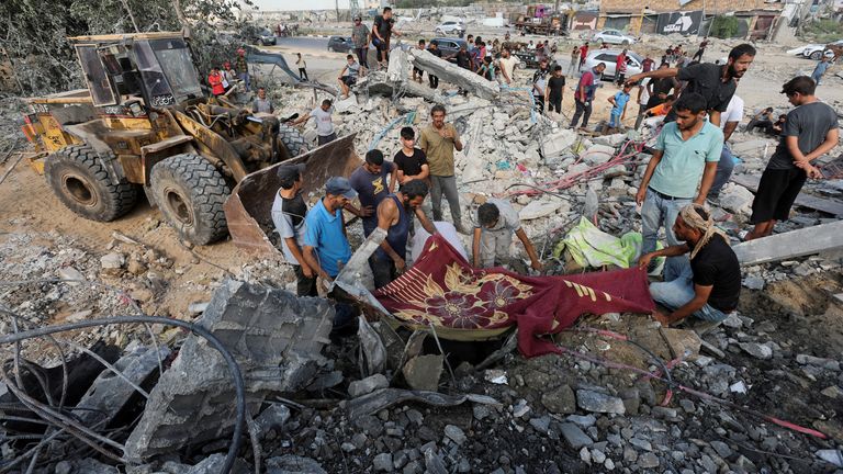 Palestinians at the site of an Israeli airstrike on a shelter in central Gaza on Saturday. Pic: Reuters