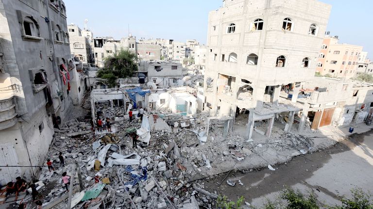 Palestinian children stand at the site of an Israeli strike on a house in the Maghazi refugee camp in Gaza.
Pic: Reuters