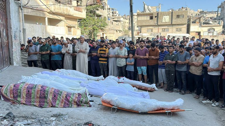 Palestinians pray next to the bodies of those killed in the attack on the school. Pic: Reuters