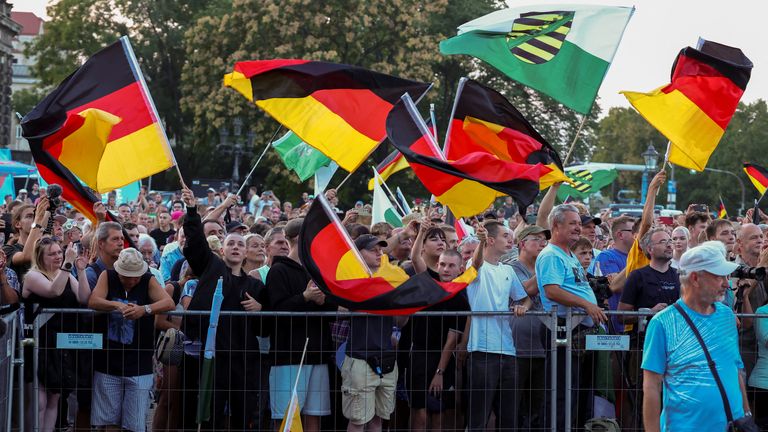 People wave German flags during an AfD rally for the Saxony state elections in Dresden. Pic: Reuters