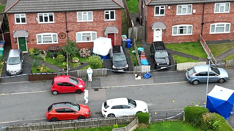 Greater Manchester police officers near a property in Barnard Road in Gorton.
Pic: PA