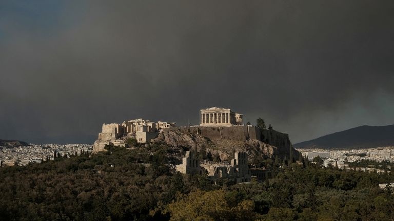 Smoke is seen behind the Parthenon temple. Pic: Reuters/Elias Marcou