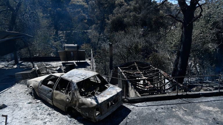 A charred vehicle after fires passed not far from Athens. Pic: AP