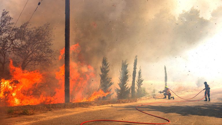 Firefighters try to extinguish a wildfire burning in Grammatiko, near Athens, Greece.
Pic: Reuters