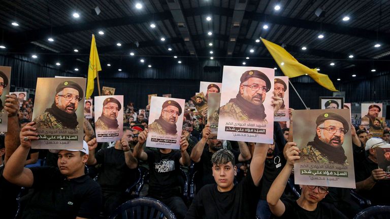 Hezbollah supporters held up portraits of Shukr. Pic: AP