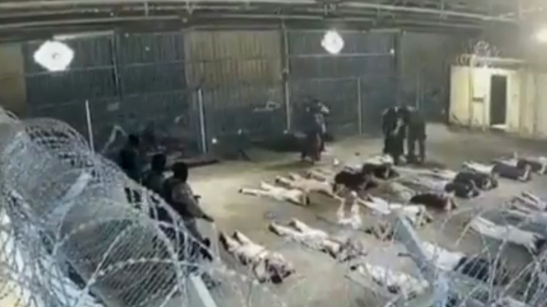 Prisoners lie face down with their hands on the back of their heads. Pic: Channel 12