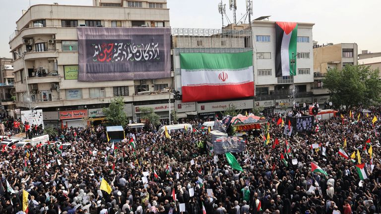 Iranians gather for the funeral of  Ismail Haniyeh and his bodyguard Wasim Abu Shaaban in Tehran.
Pic: Reuters