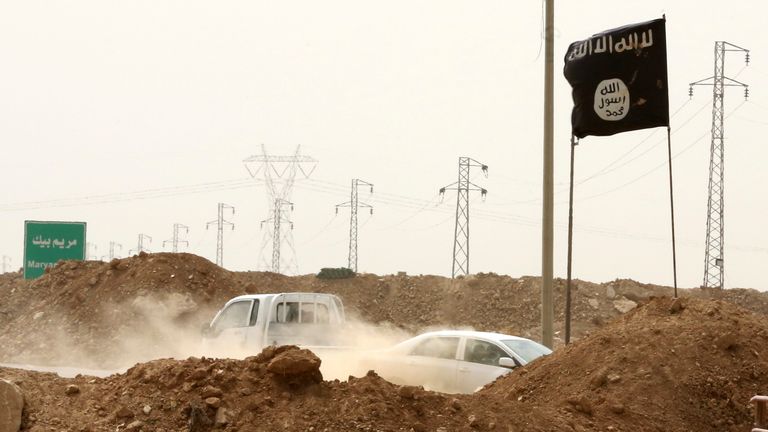 Islamic State militants pass a checkpoint bearing the group's black flag in Iraq. File pic: AP