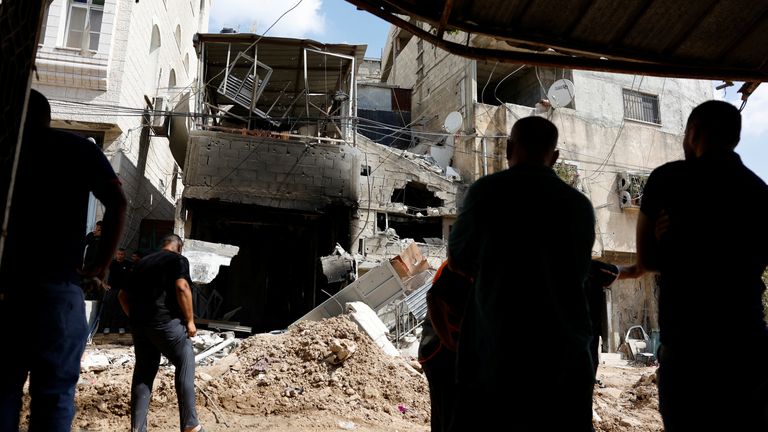 Palestinians inspect a damaged house following an Israeli military raid in Tulkarm. Pic: Reuters