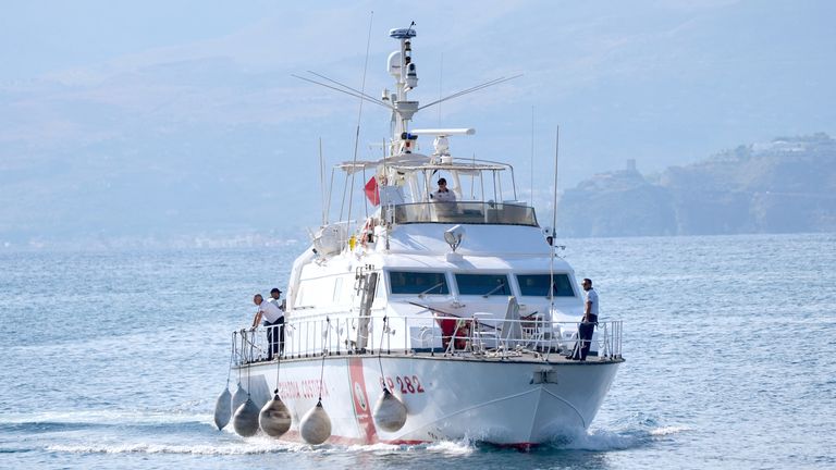 The Italian Coast Guard returns to Porticello Harbour on the Sicilian coast on the third day of the search.
Pic: PA