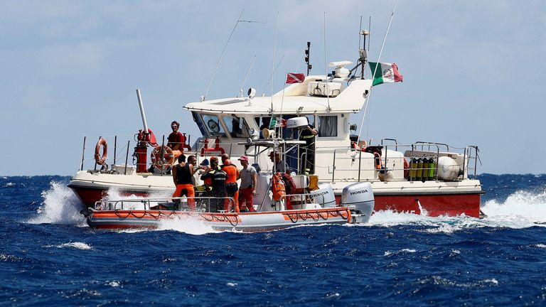 Rescue personnel work in the area where a luxury yacht sank, off the coast of Porticello, near the Sicilian city of Palermo, Italy, August 20, 2024. REUTERS/Guglielmo Mangiapane
