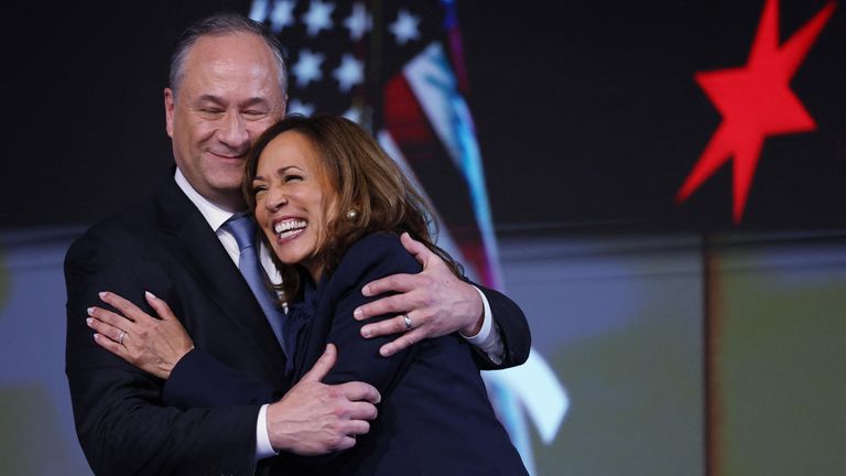 Democratic presidential nominee and U.S. Vice President Kamala Harris embraces her husband Doug Emhoff, second gentleman of the U.S., on Day 4 of the Democratic National Convention (DNC) at the United Center in Chicago, Illinois, U.S., August 22, 2024. REUTERS/Kevin Wurm