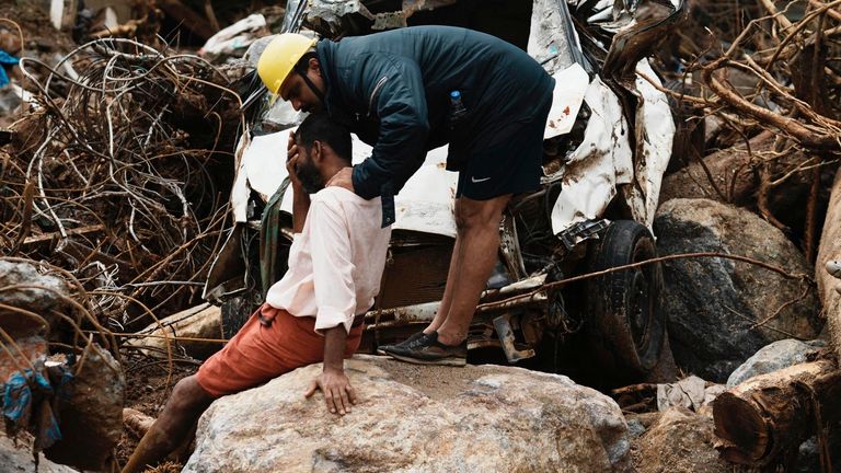 A rescuer consoles a man who lost his home following Tuesday's landslides at Chooralmala, Wayanad district, Kerala state, India, Wednesday, July 31, 2024. (AP Photo/Rafiq Maqbool)