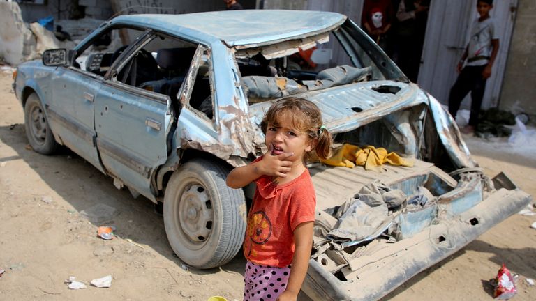 A Palestinian child stands near a damaged vehicle, after Israeli forces withdrew from the area, following a ground operation, amid the ongoing conflict between Israel and Hamas, in Khan Younis, in the southern Gaza Strip, August 30, 2024. REUTERS/Hatem Khaled
