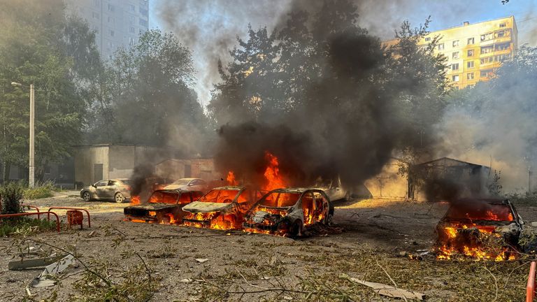 Cars burn after a Russian air strike in Kharkiv.
Pic: Reuters